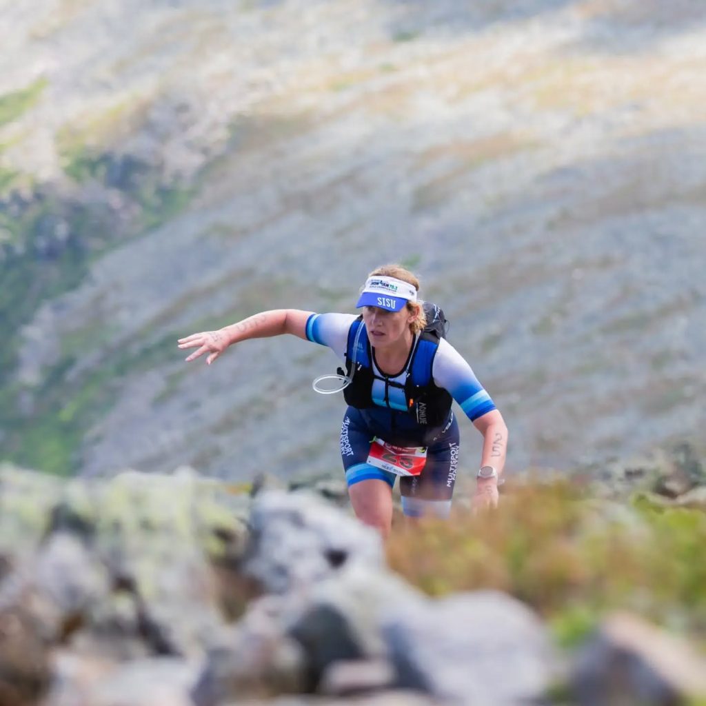 Multisport Mastery athlete climbing a rocky mountain trail during the Sea to Summit race