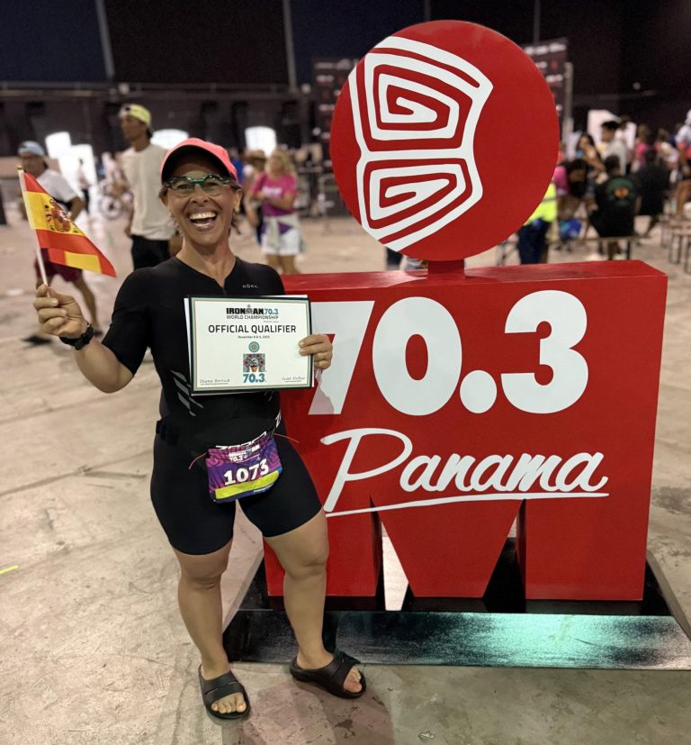 Liz holding her finisher certificate at IRONMAN 70.3 Panama