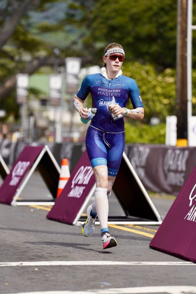 Triathlete in a Multisport Mastery kit on the Kona run course